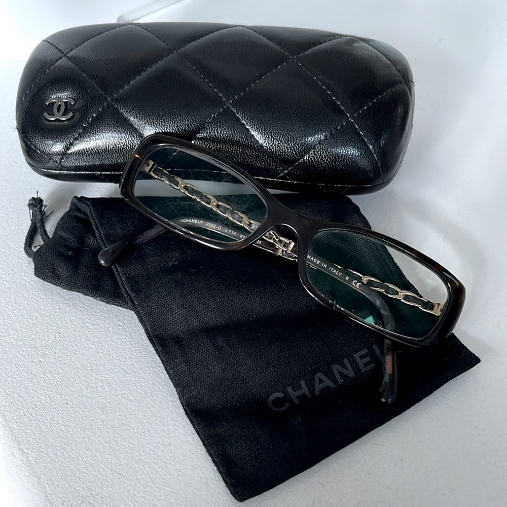 Prescription glasses, Chanel brand. Dark brown with gold accents.